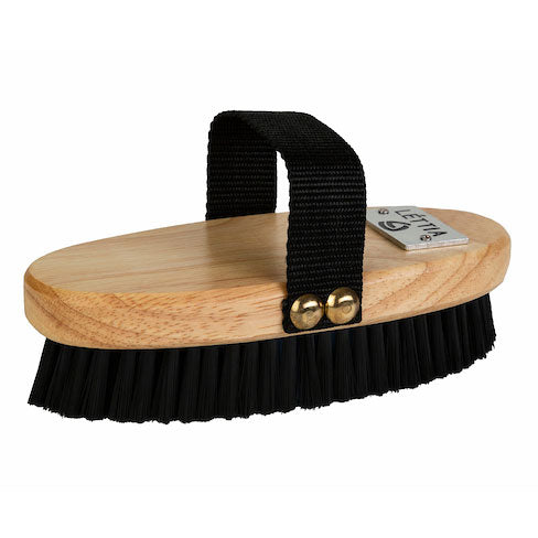 Oval wooden body brush with black bristles and a black hand strap, side view on white