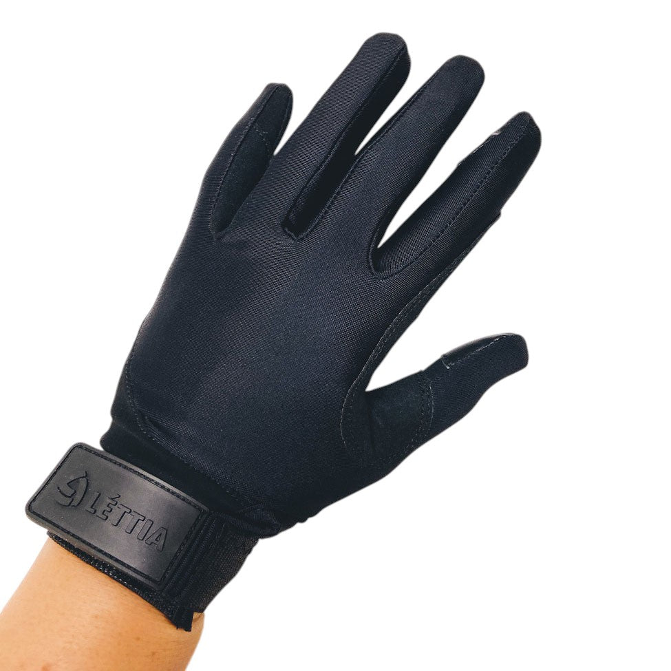 Black riding glove on a hand with a wrist strap showing the Lettia name, back of hand view on white