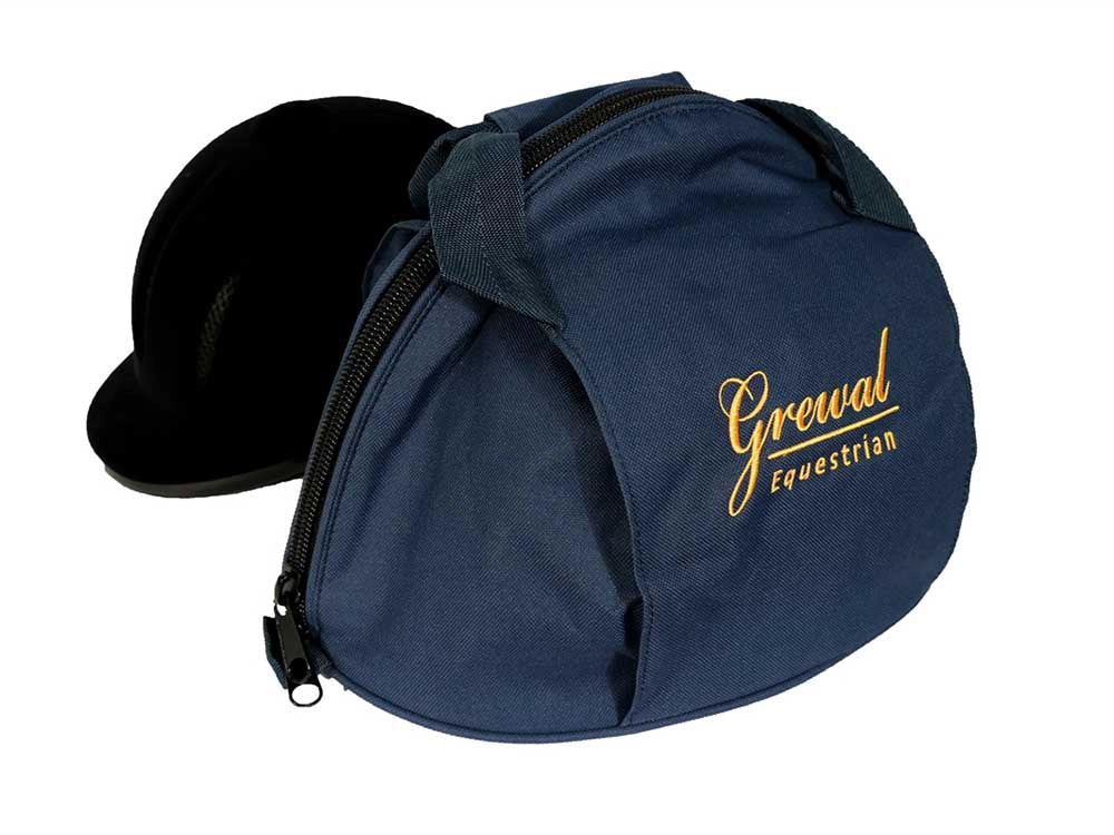 Royal blue helmet bag with gold Grewal Equestrian lettering, partly unzipped with a black riding helmet inside