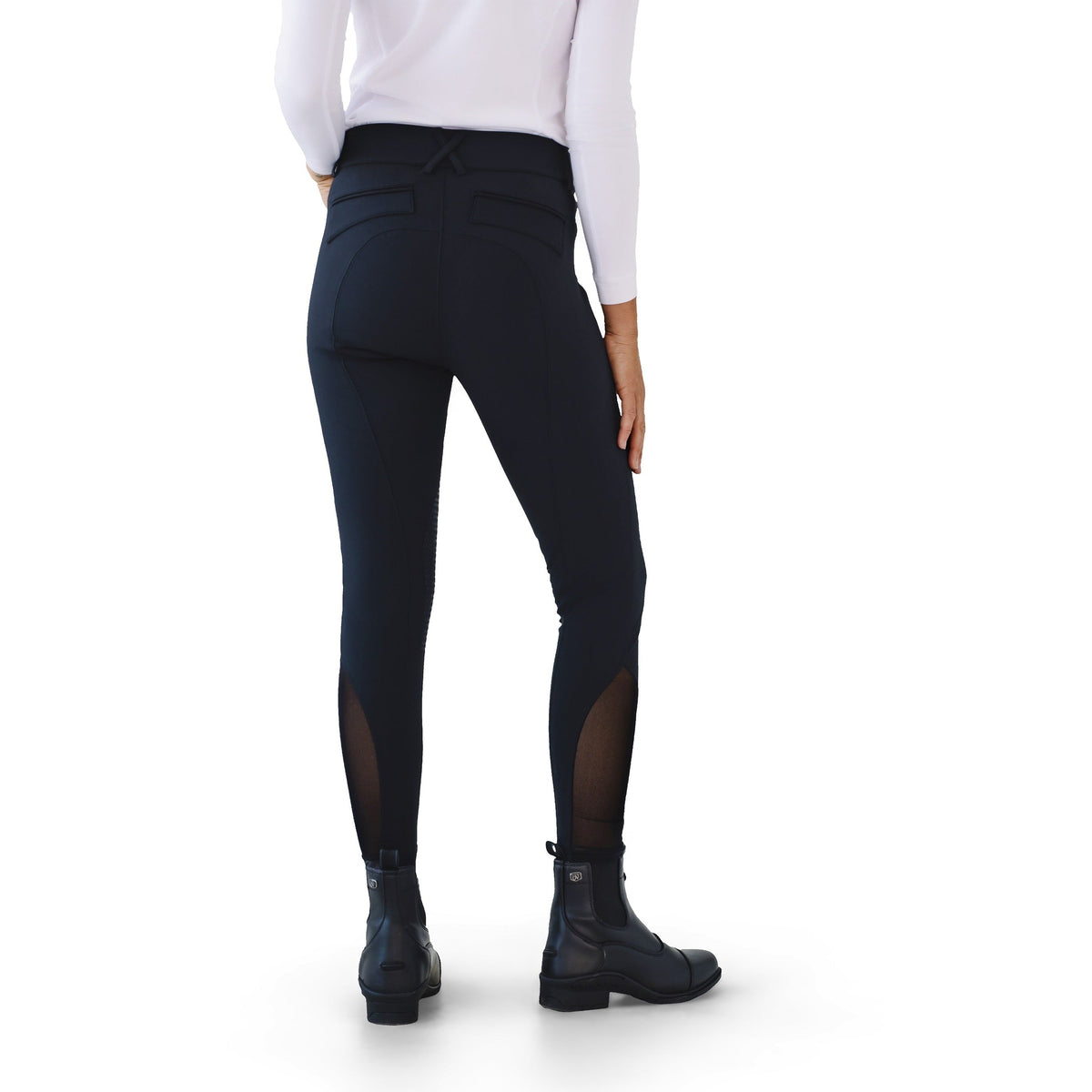 Back view of the black breeches with sheer lower leg panels and black paddock boots, on white