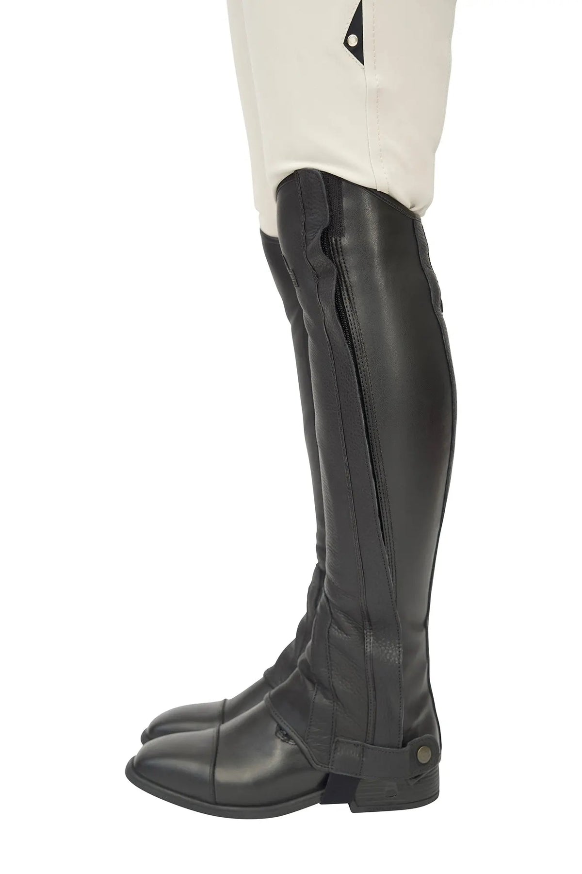 Single black half chap from the opposite side, toe pointing left, with a snap tab at the ankle
