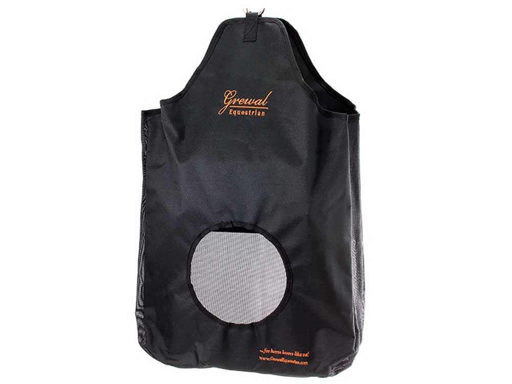 Empty black hay bag on white with a top hanging strap and a round mesh opening on the front