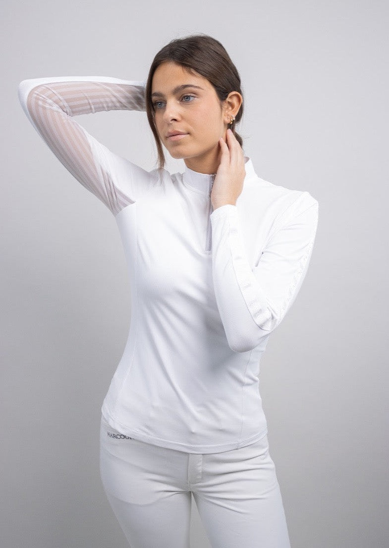 White quarter zip long sleeve shirt with sheer mesh sleeves, worn with white breeches by a model