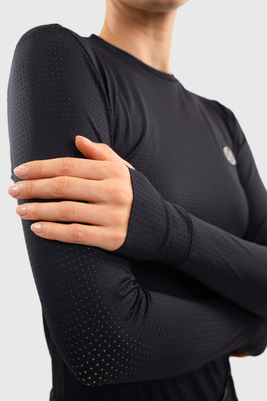 Dark long sleeve crew neck top with perforated sleeves, close crop on a model with arms folded