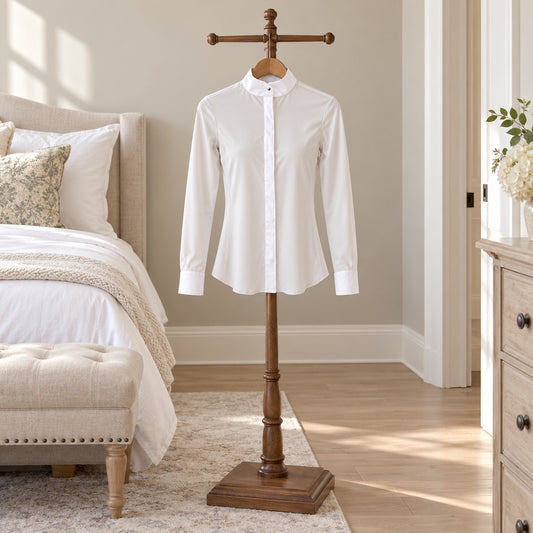 White long sleeve show shirt with a band collar on a wooden valet stand in a bedroom