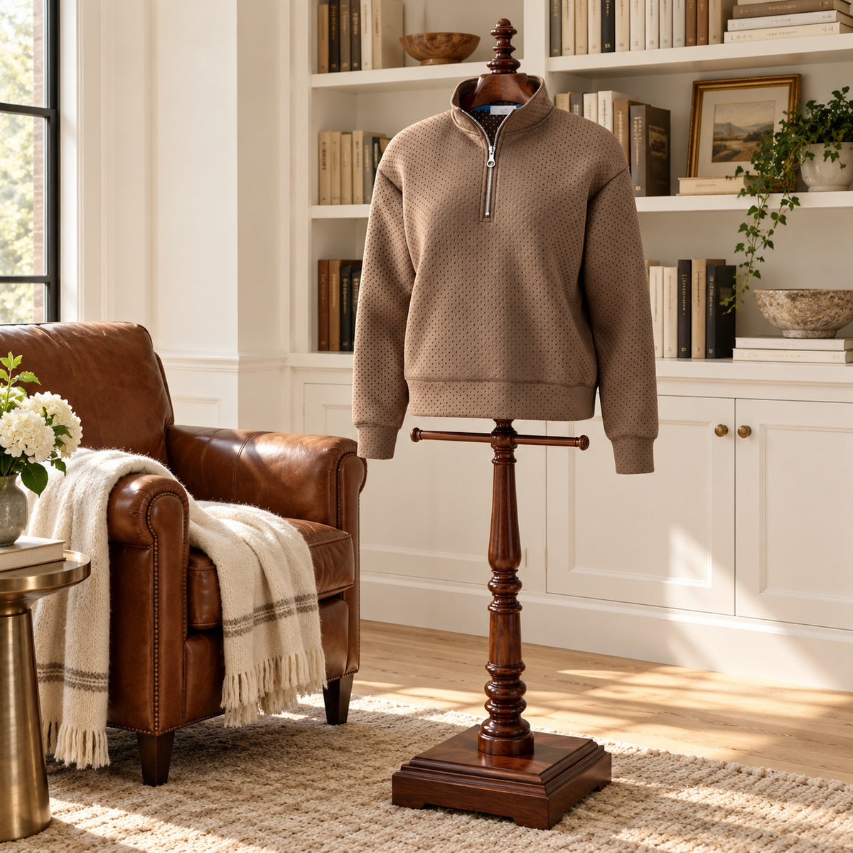 Taupe textured half zip pullover with a funnel neck on a wooden valet stand in a library sitting room