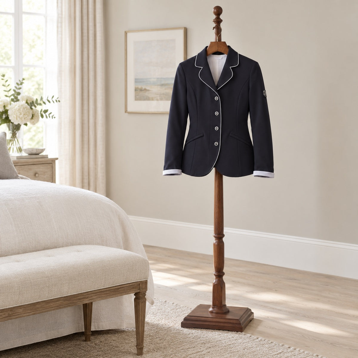 Cella Competition Jacket in navy on a wooden valet stand in a bedroom