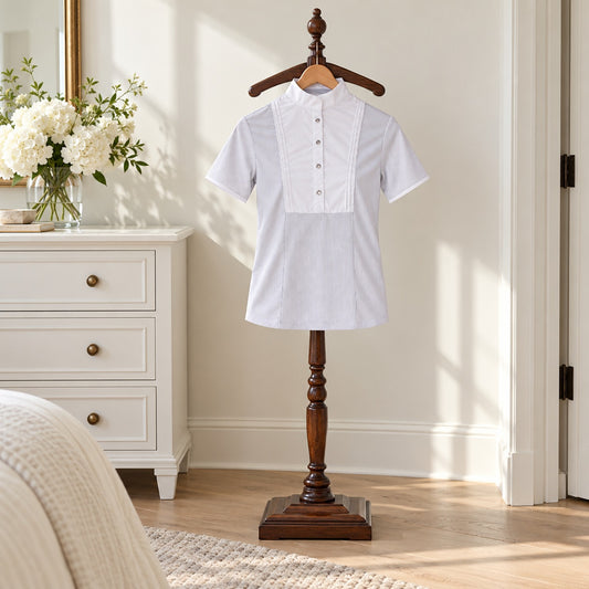 White short sleeve show shirt with a pleated bib and stand collar on a wooden valet stand in a bright bedroom