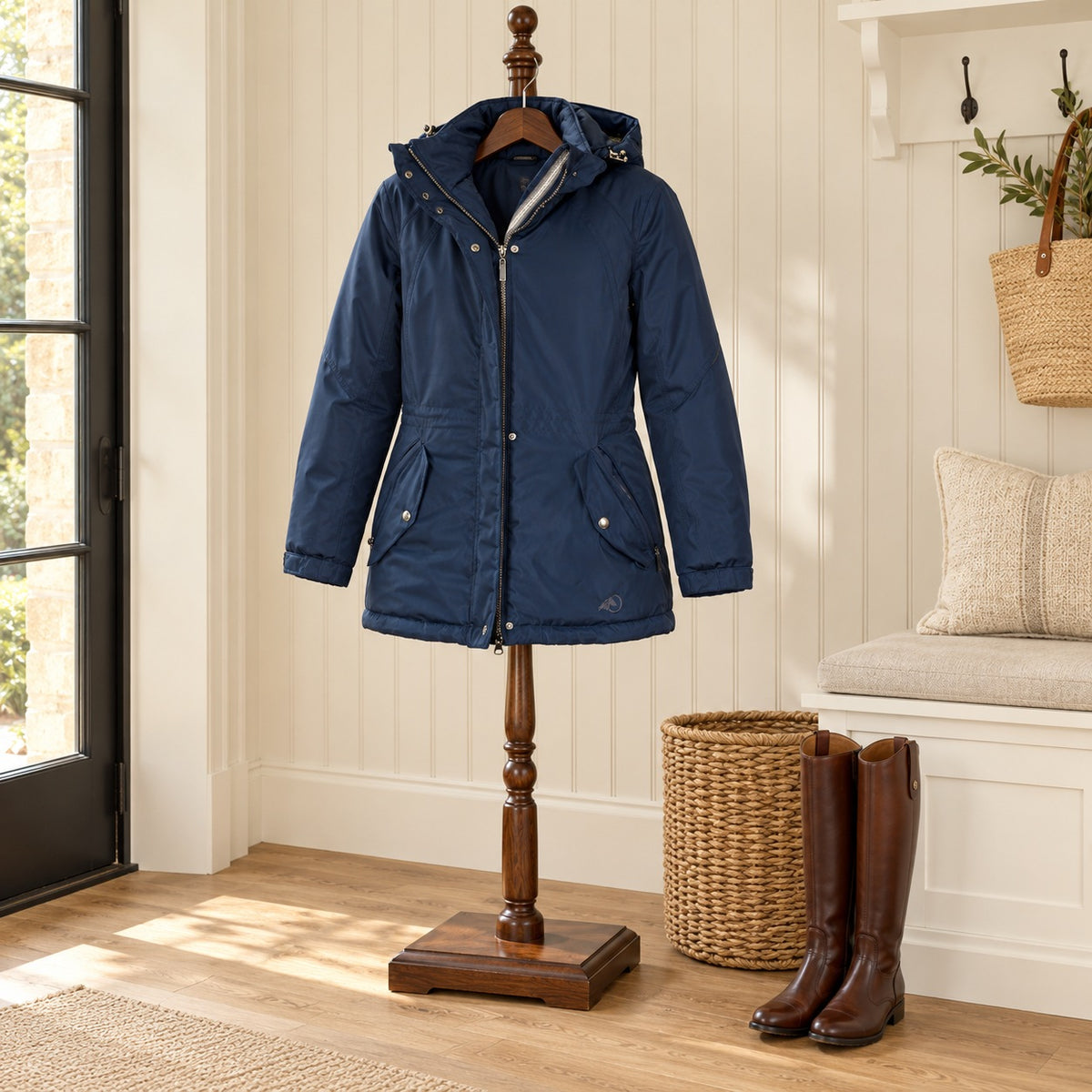 Oak Equestrian Ladies Winter Parka in navy on a wooden valet stand in a mudroom