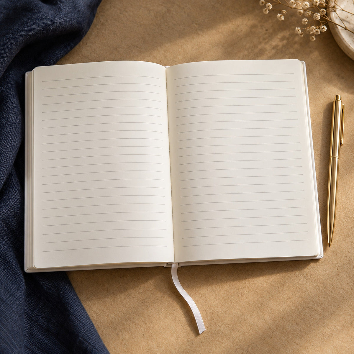The notebook open flat showing 80 lined pages on cream paper, with a gold pen alongside.