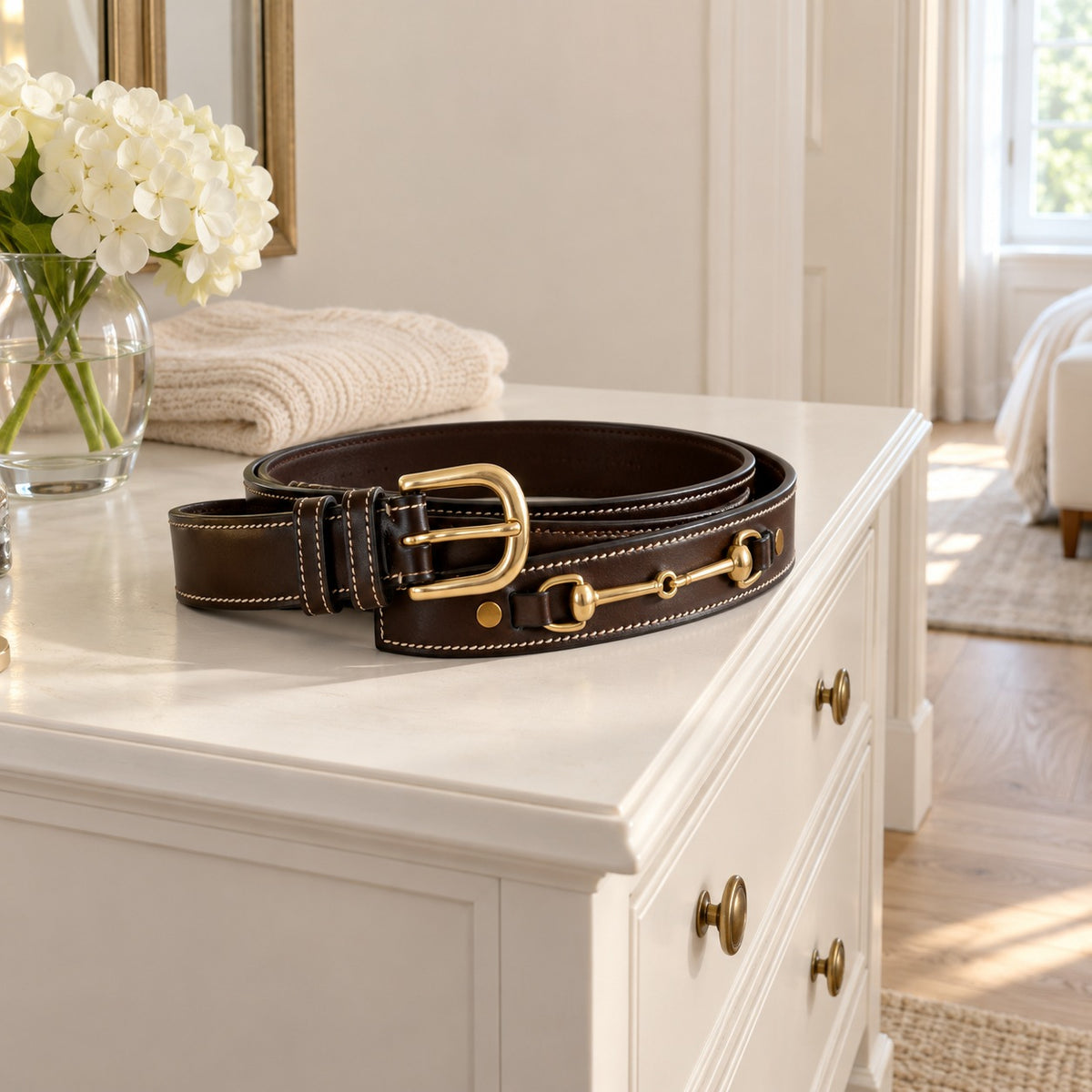 ExionPro Double Snaffle Belt coiled on a white dresser