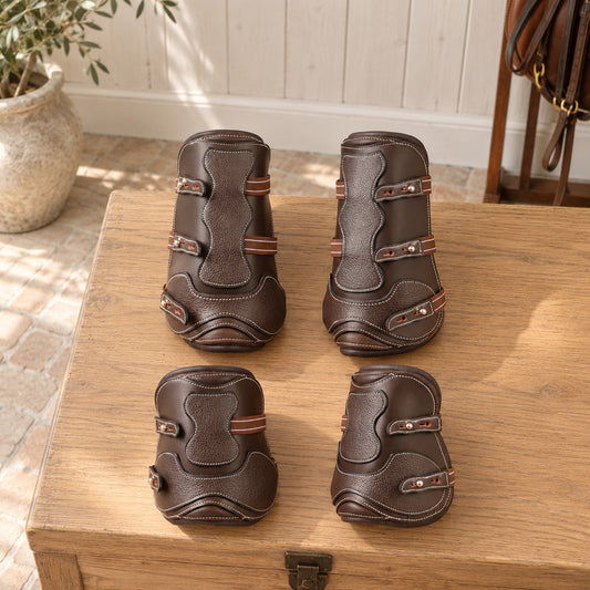 ExionPro Leather Tendon Boots front and hind pairs on a tack trunk