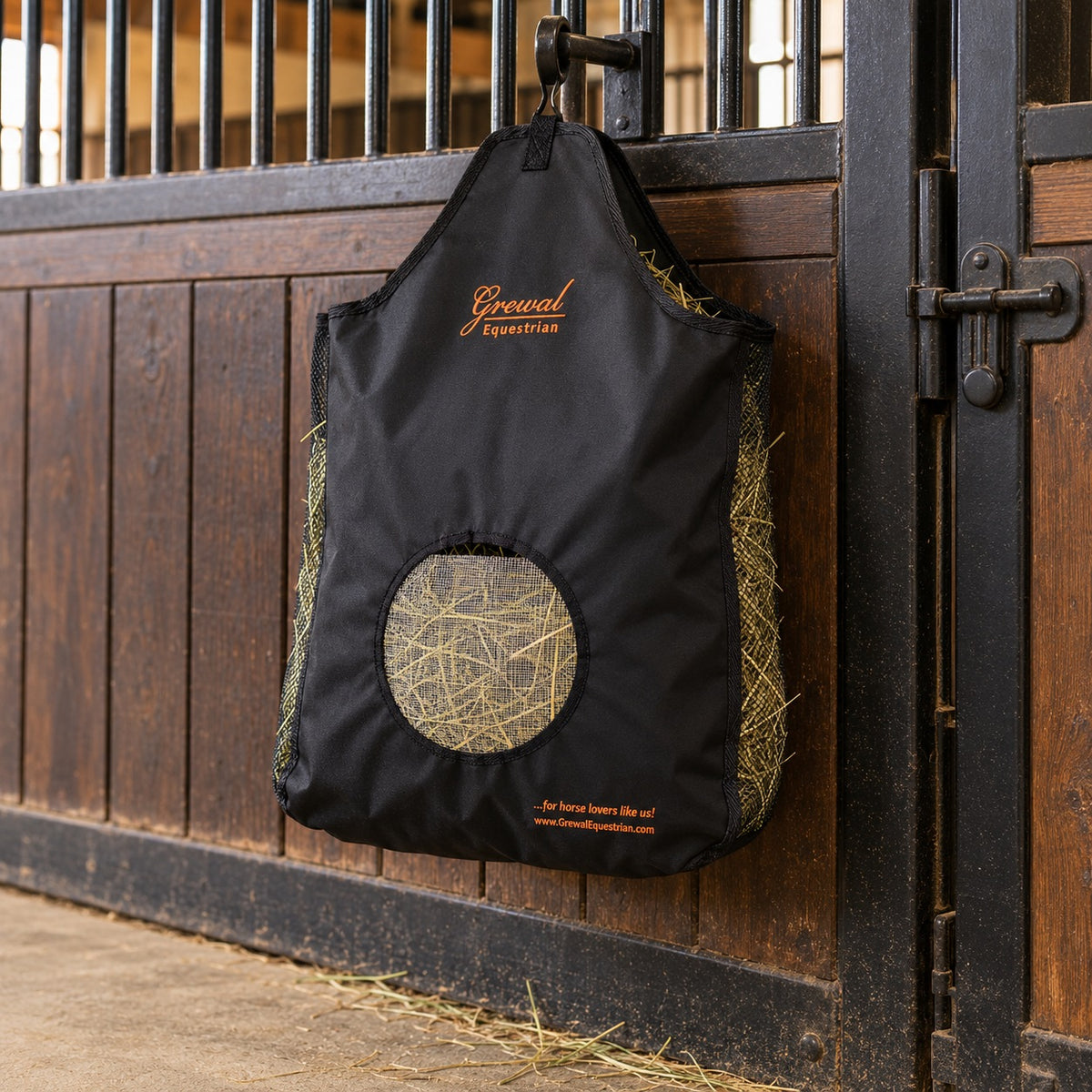 Grewal Small Black Hay Bag hanging filled with hay on a stall front