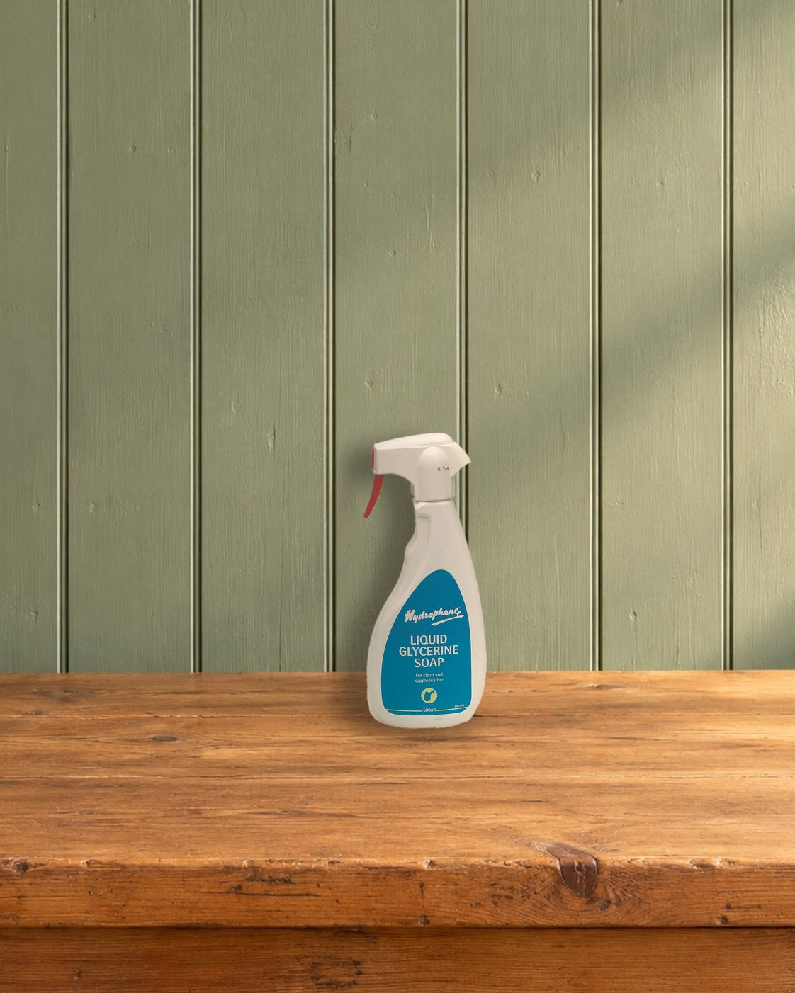 Hydrophane Liquid Glycerine Soap spray bottle on a pine counter against a sage green plank wall