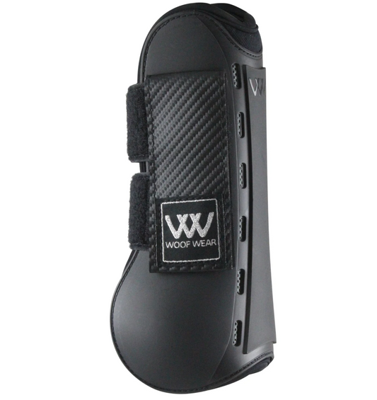 Woof Wear Pro Tendon Boot in white shown on a horse's front leg, displaying the semi-rigid shell construction, fetlock guard, and hook-and-loop closure system